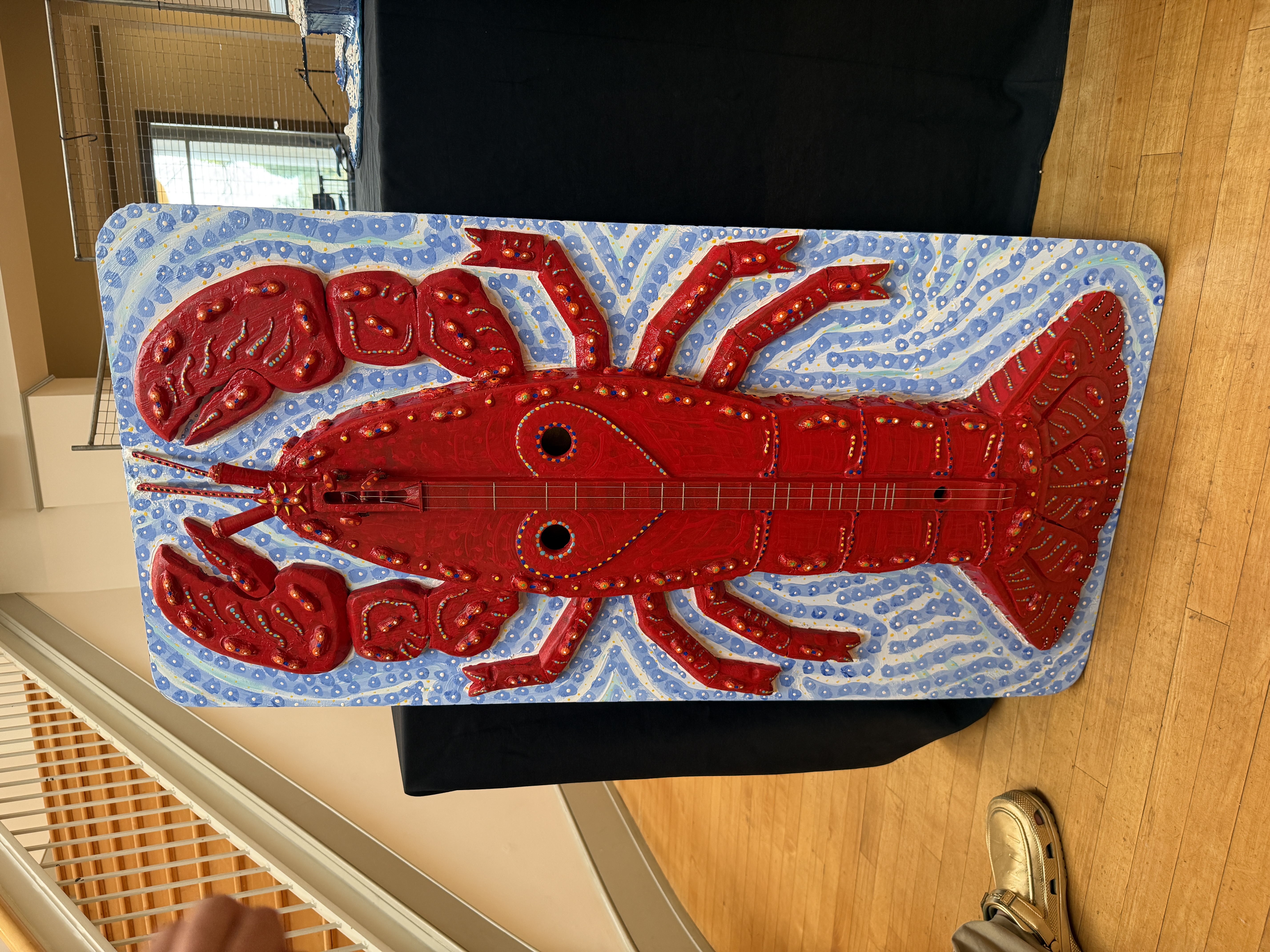 The lobster dulcimer, leaning against a table at the Lyndon House Arts Center. It stands nearly five feet tall.