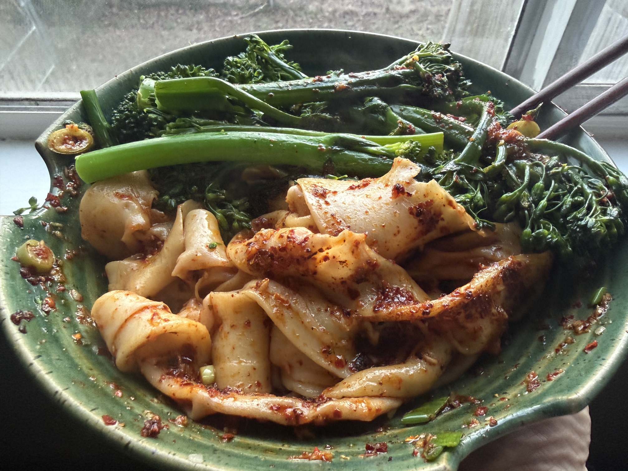Biang biang noodles with chili oil and broccolini in a green ceramic bowl. The Epic 2 build session: 13 story points, 3 PRs, 10 minutes of my attention.